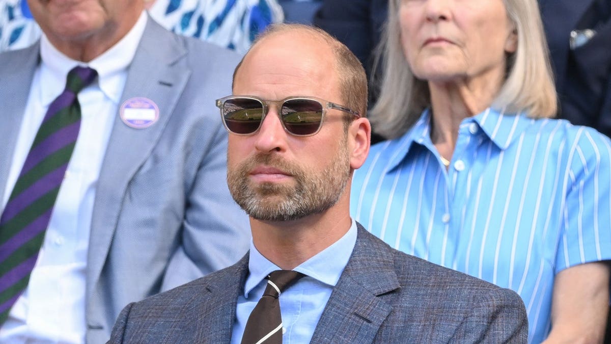 Prince William smiles at Wimbledon in London.