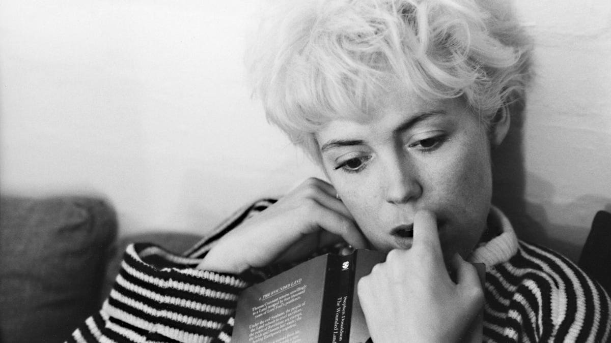 Roland Orzabal's first wife Caroline in reflection while reading a book.