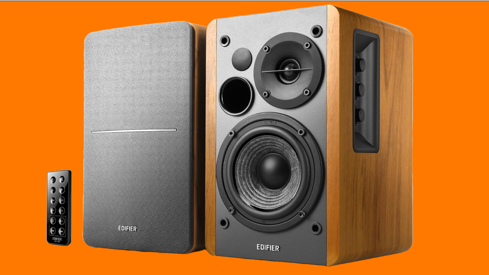 The Edifier R1280DB speakers and their remote in front of an orange background.