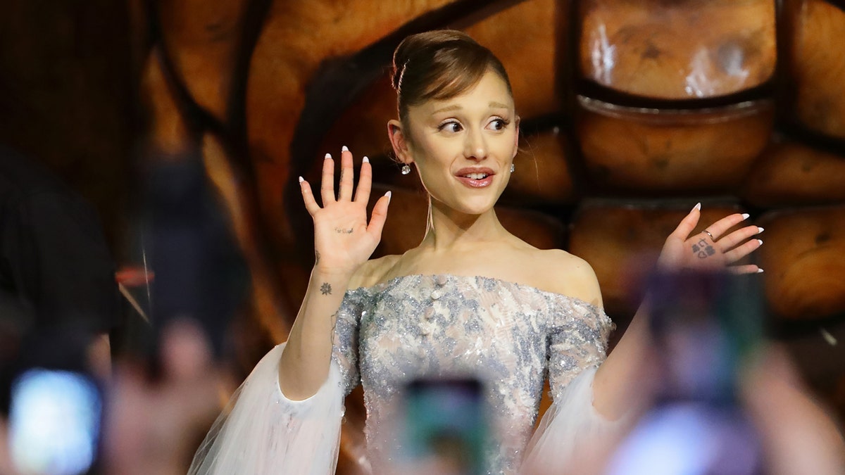 Ariana Grande waves to the crowd at the Wicked Singapore premiere