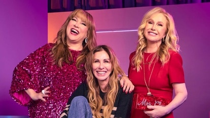 Jennifer Tilly, Carole Radziwill and Kathy Hilton laughing in front of a purple set at BravoCon