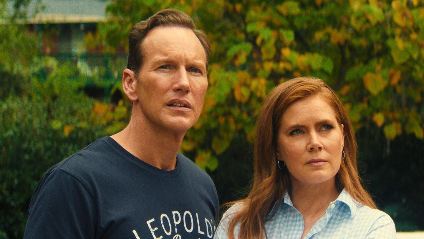 Production still from Apple TV's Cape Fear showing Patrick Wilson and Amy Adams standing together.