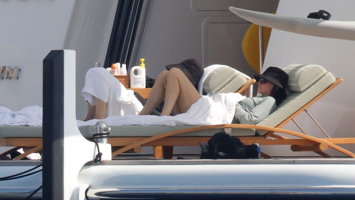 Courteney Cox relaxing on a lounge chair while on a yacht in Mallorca in July 2026.