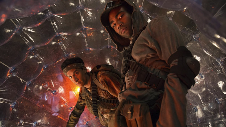 Troy and Abed in a plastic ball, dressed as post-apocalyptic warriors, in Community