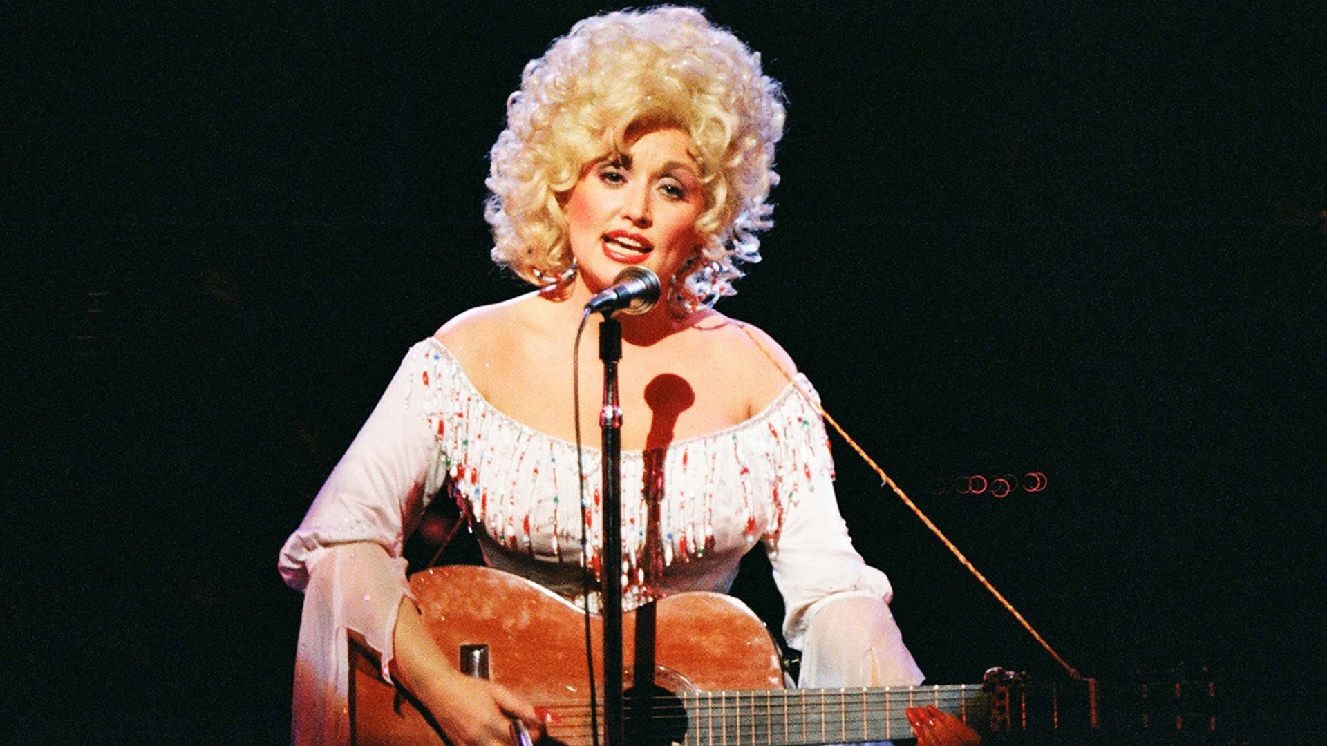 Dolly Parton in 1983 in pink.