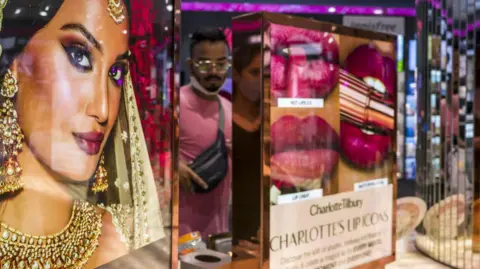Bloomberg via Getty Images An advertisement for Charlotte Tilbury with a model dressed as an Indian bride at a Nykaa beauty store in New Delhi, India.