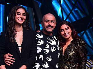 Ananya Panday (L) and Bhumi Pednekar (R) pose with singer/composer Vishal Dadlani on the set of music reality show 'Indian Idol 11