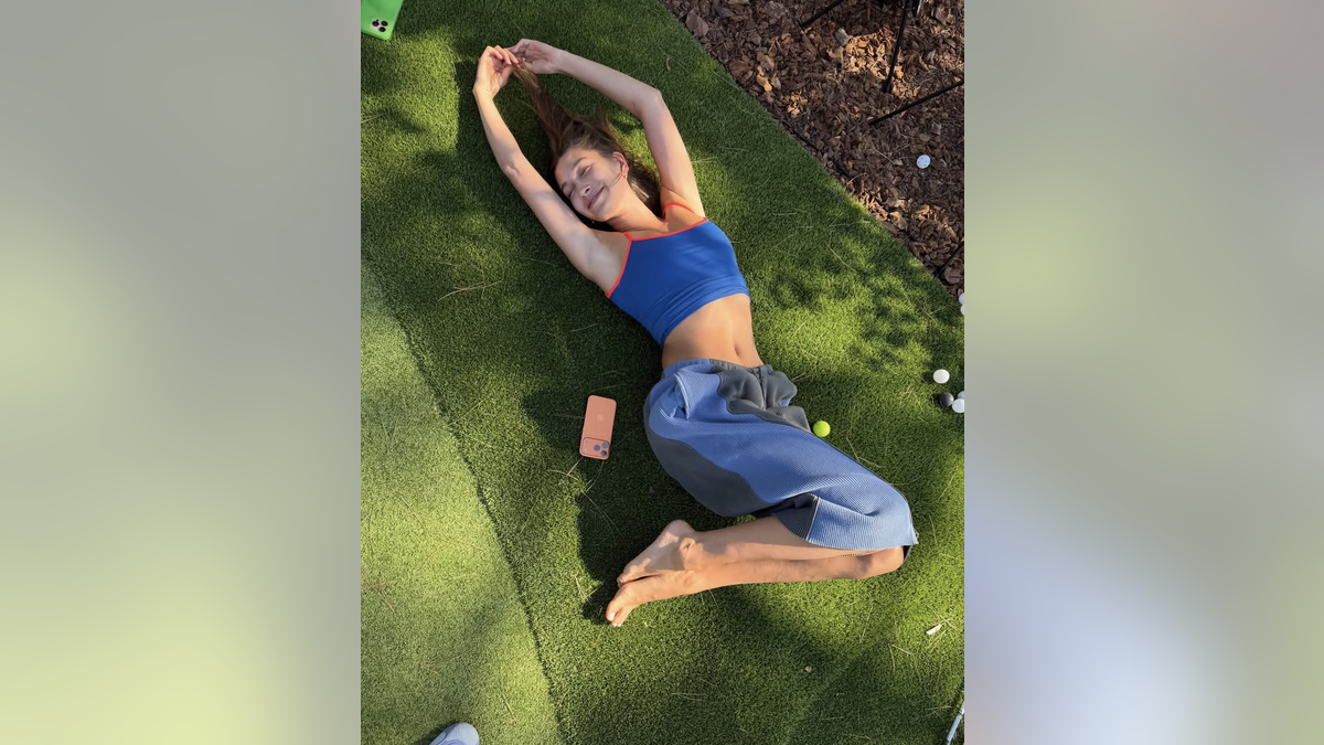 Hailey Bieber in grass