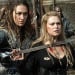 A woman held hostage by sword in a still from The 100.