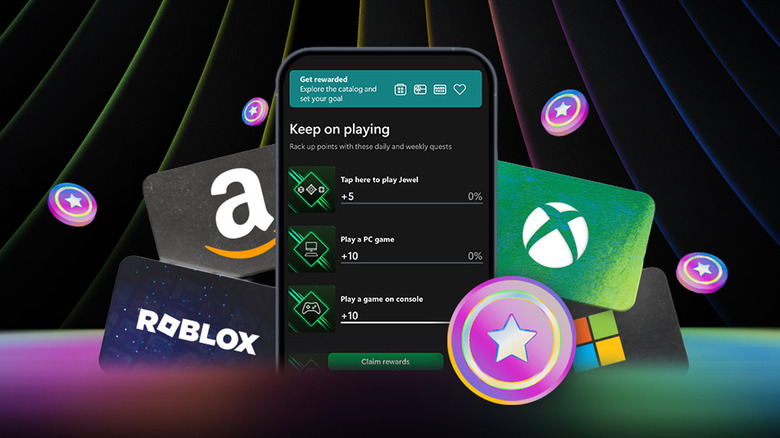 A phone showing a screen full of reward selections. In the background are gift cards to Amazon, Roblox, Xbox and Windows.