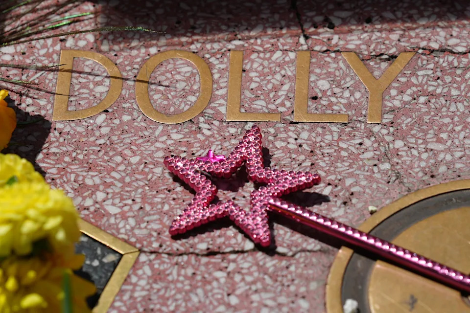 A wand with a star is placed over Dolly Parton's star on the Hollywood Walk of Fame Tuesday, Aug. 25, 2026, in Los Angeles. (AP Photo/Chris Pizzello)