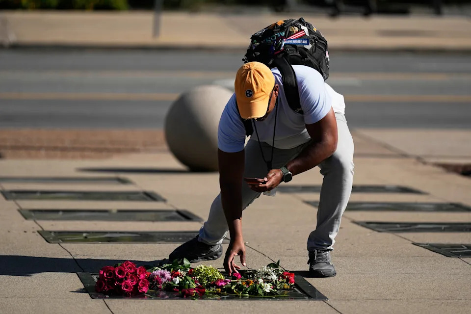 A person lays flowers at Dolly Parton's star on the Music City Walk of Fame outside the Country Music Hall of Fame on Tuesday, Aug. 25, 2026, in Nashville, Tenn. (AP Photo/George Walker IV)