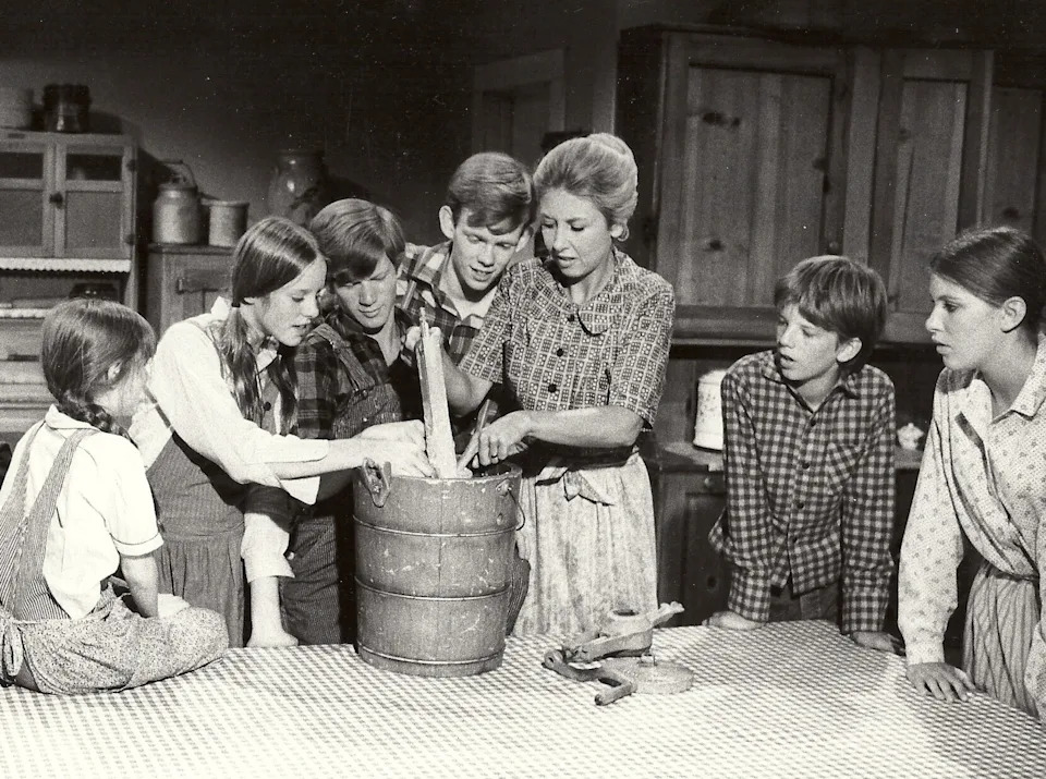 The Waltons children gather around Olivia Walton to make ice cream on "The Waltons".