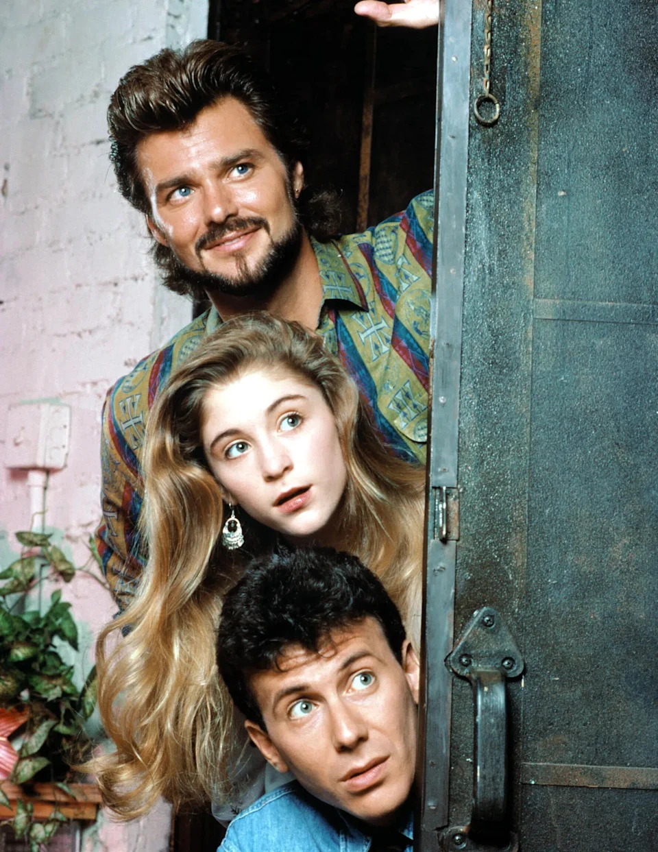 Paul Reiser and Greg Evigan standing with Staci Keanan on the set of the sitcom My Two Dads