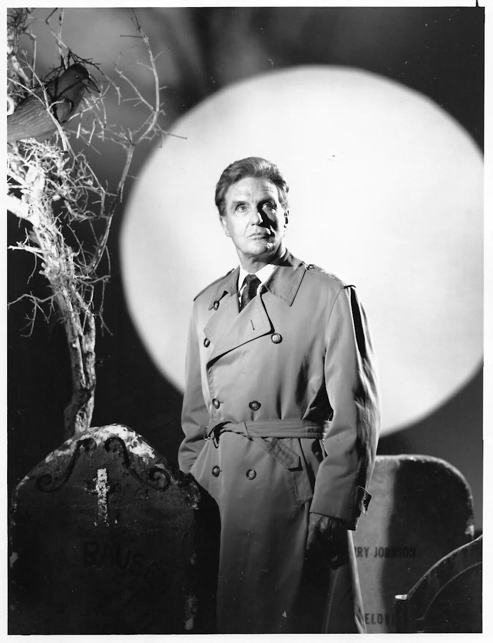 Robert Stack in his trench coat hosting the television series Unsolved Mysteries