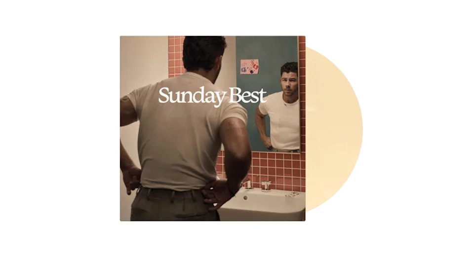 A man in a white shirt looks at his reflection in a bathroom mirror with "Sunday Best" text overlay. Orange tiled wall background.