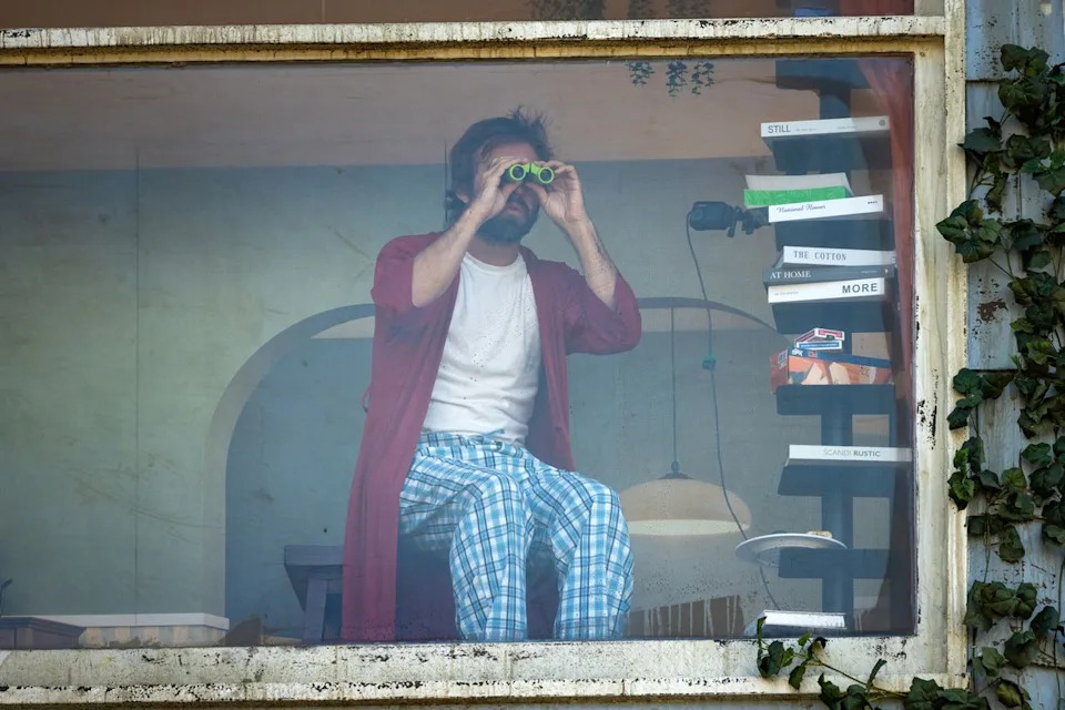 The man in 'The Last House' billboard takes in the view with binocularsCredit: Joel Barhamand/Netflix