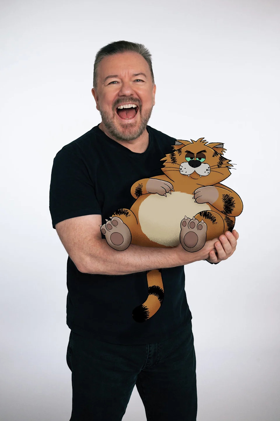 Ricky Gervais poses with Gus, the cartoon cat he voices in 'Alley Cats' (Netflix)