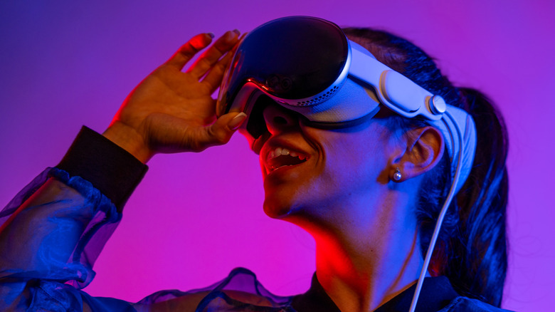 A woman using an Apple Vision Pro headset