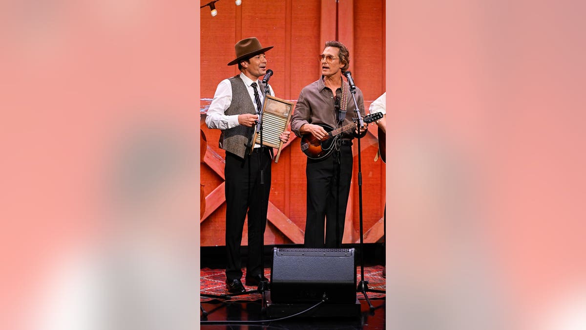 Jimmy Fallon and Matthew McConaughey stand together onstage during a television taping.