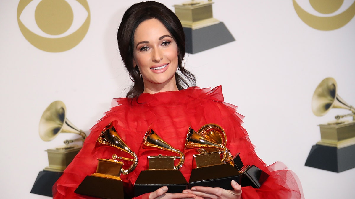 Kacey Musgraves holding Grammys