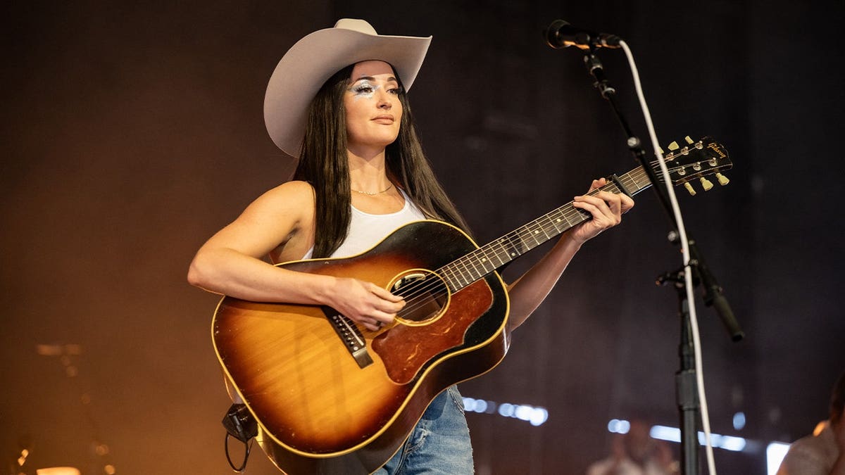 Kacey Musgraves wears a white cowboy hat on stage