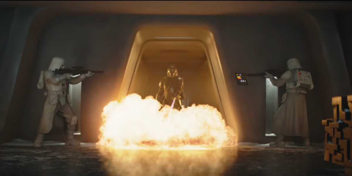 Din Djarin using a flamethrower on two snow troopers in ''The Mandalorian and Grogu''
