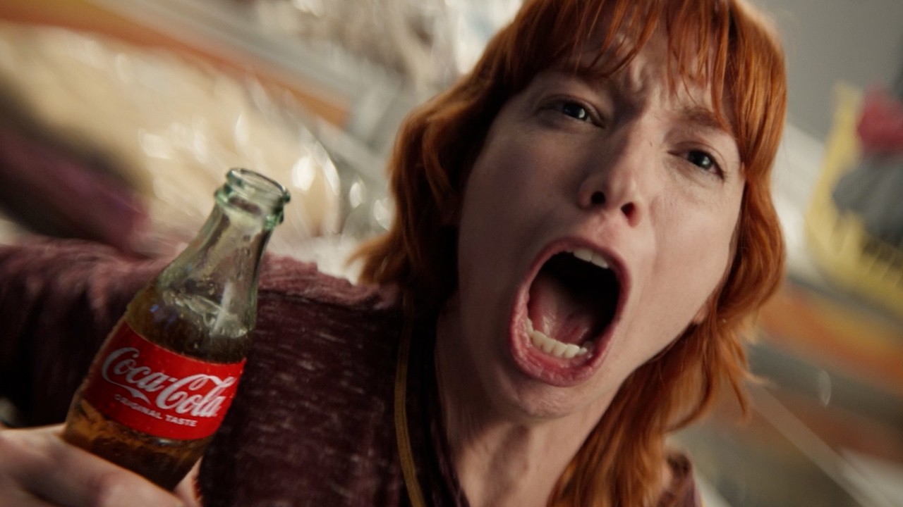 Fans enjoy a refreshing Cola-Cola while watching a football game