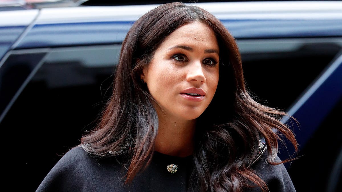Meghan, Duchess of Sussex signs a book of condolence at New Zealand House in London.