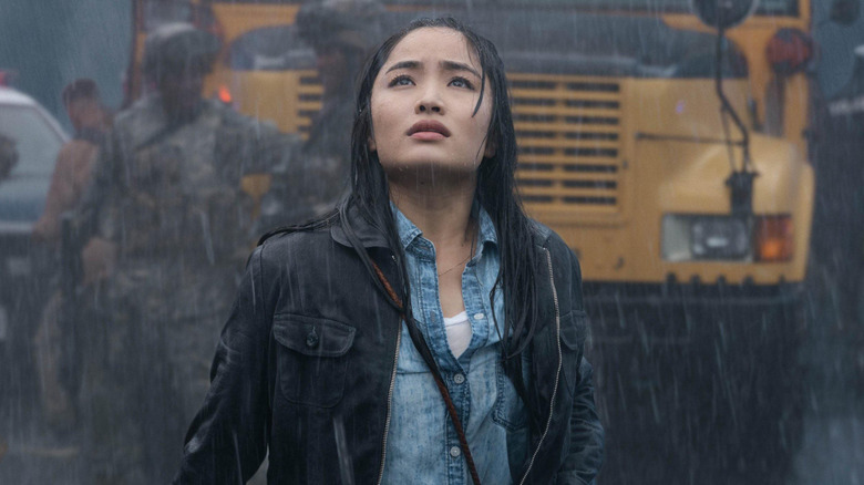 Anna Sawai as Cate Randa standing in the rain looking up in Monarch