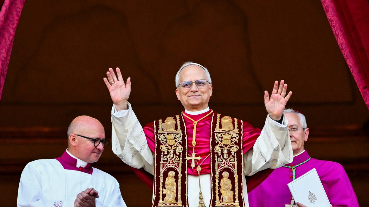 Pope Robert Francis Prevost stands on the central loggia balcony of St. Peter's Basilica.
