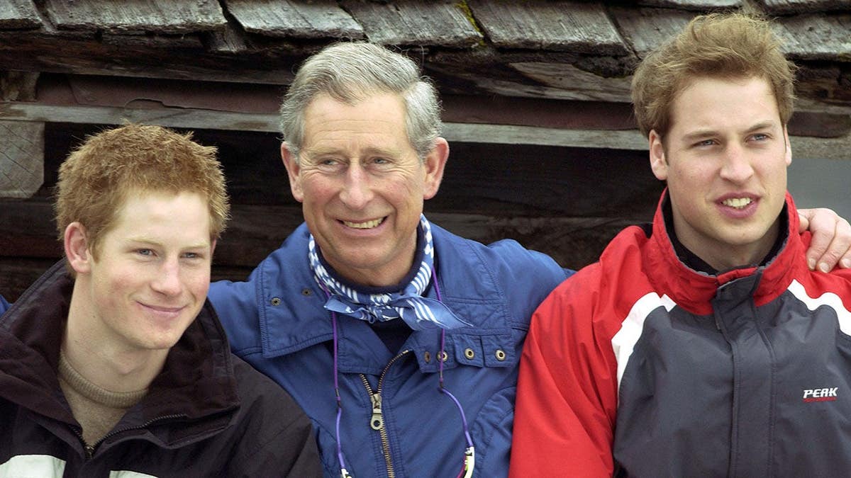 Prince Charles poses with his arms around Prince William and Prince Harry during a ski break.