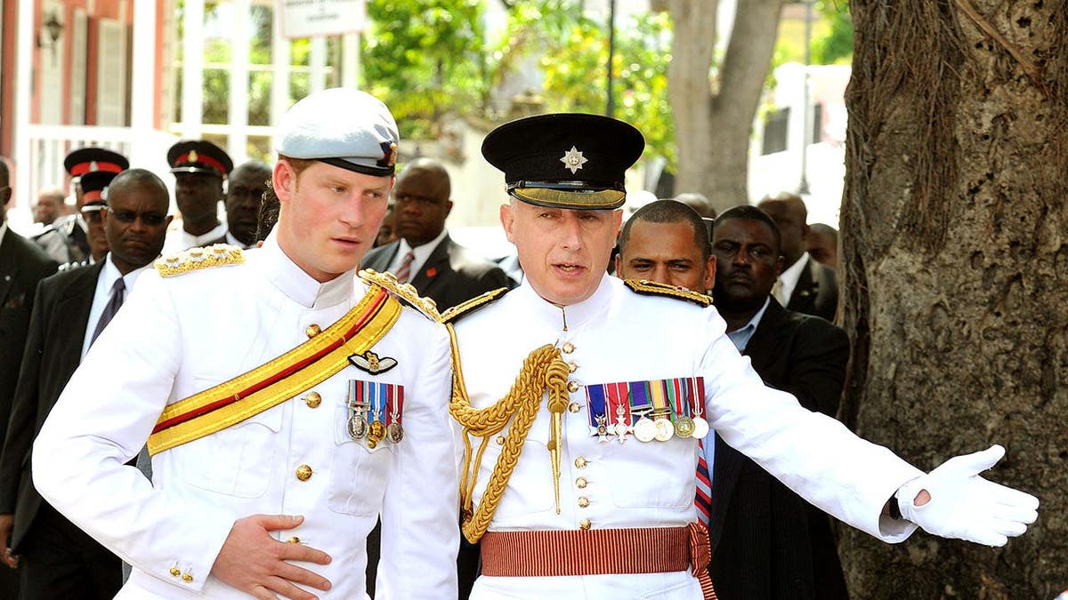 Prince Harry walks with Jamie Lowther-Pinkerton after a service at Christ Church Cathedral.