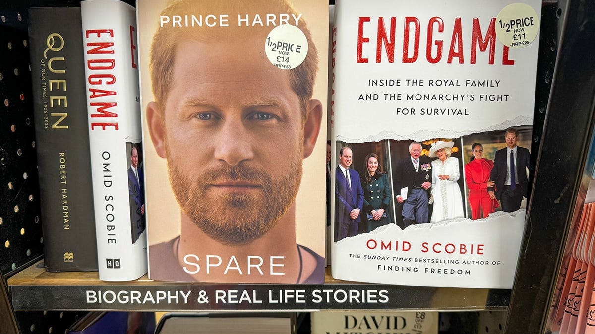 Prince Harry's Spare and Omid Scobie's Endgame books displayed in a bookstore.