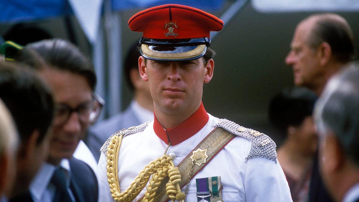 Queen Elizabeth II stands with Hugh Lindsay, equerry, in Trinidad and Tobago.