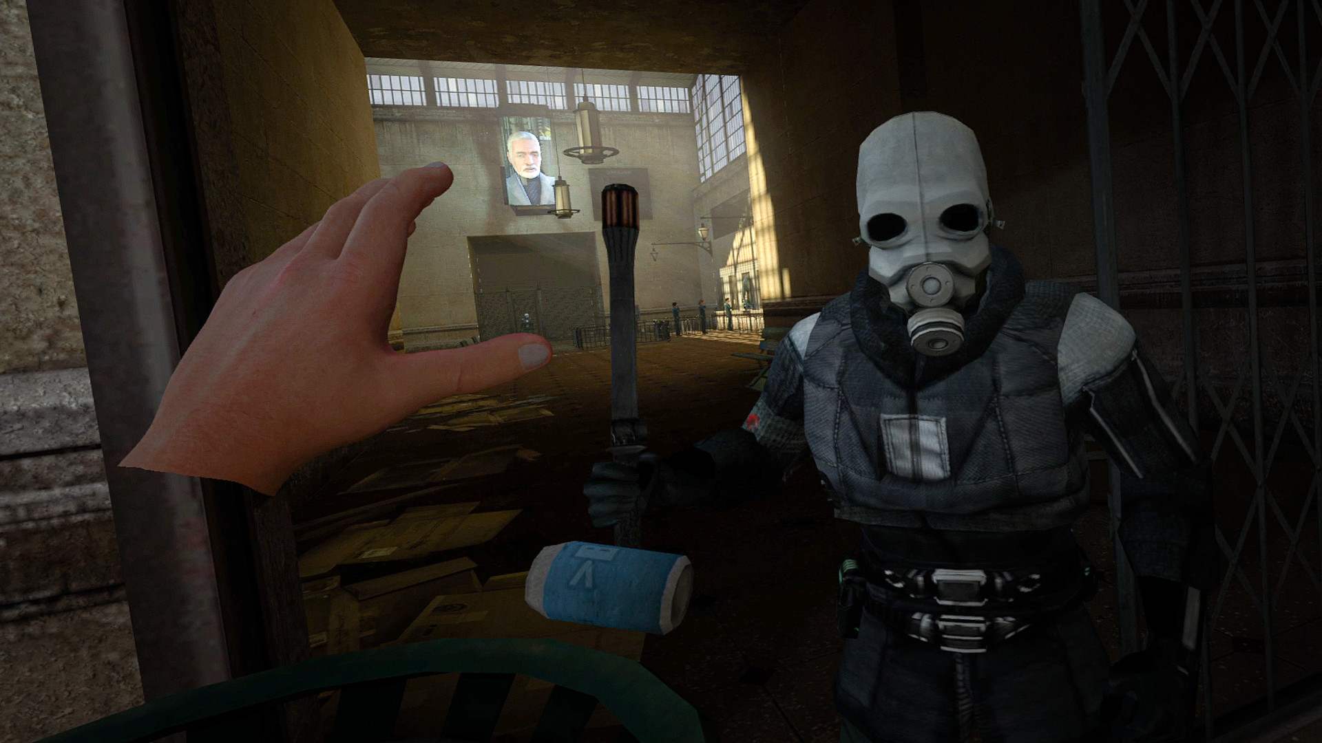 First-person view in Half-Life 2: VR Mod showing a tracked virtual hand reaching out beside a Combine soldier in the City 17 train station