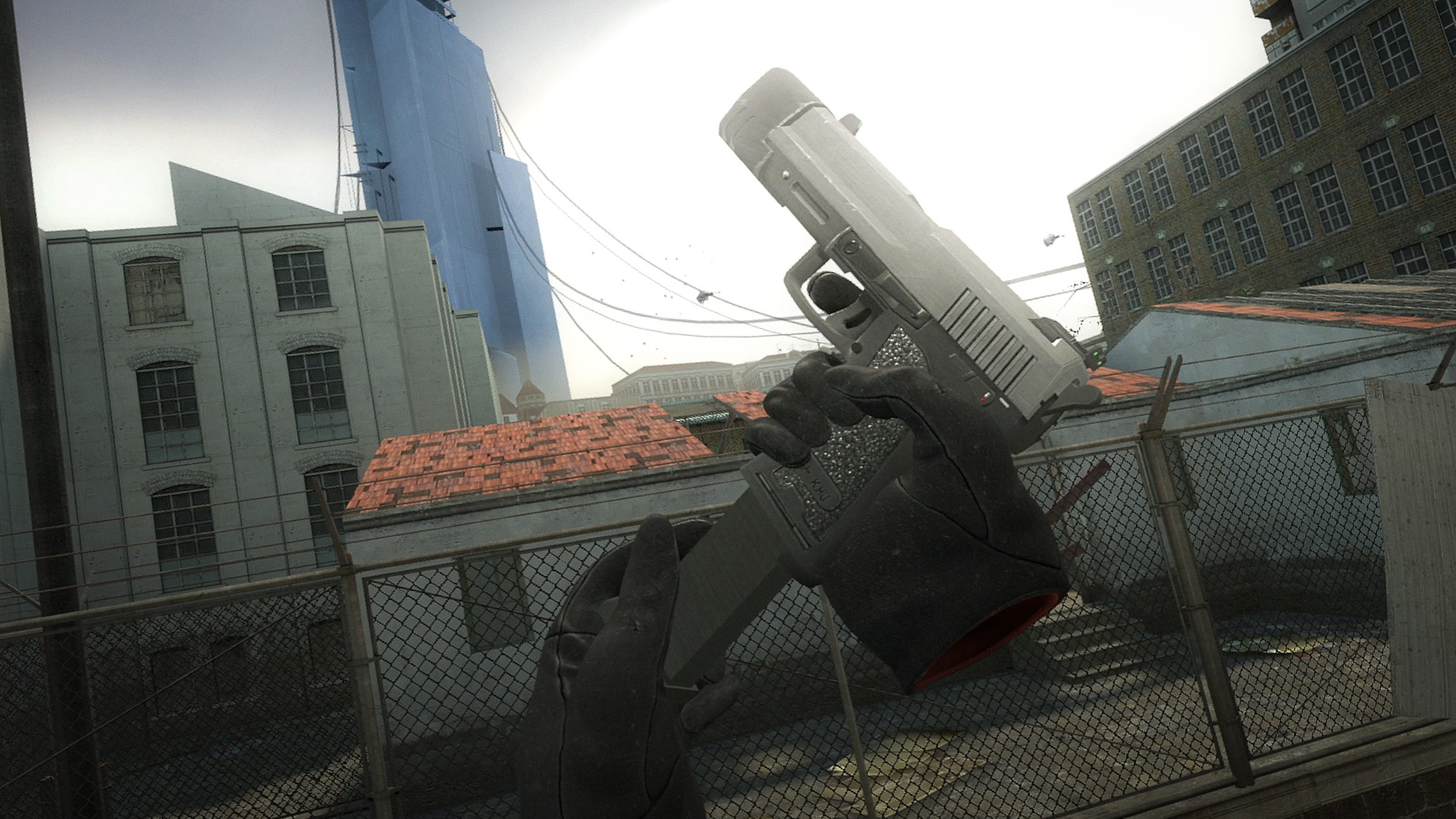 Two tracked hands loading a magazine into a pistol on a rooftop in Half-Life 2: VR Mod