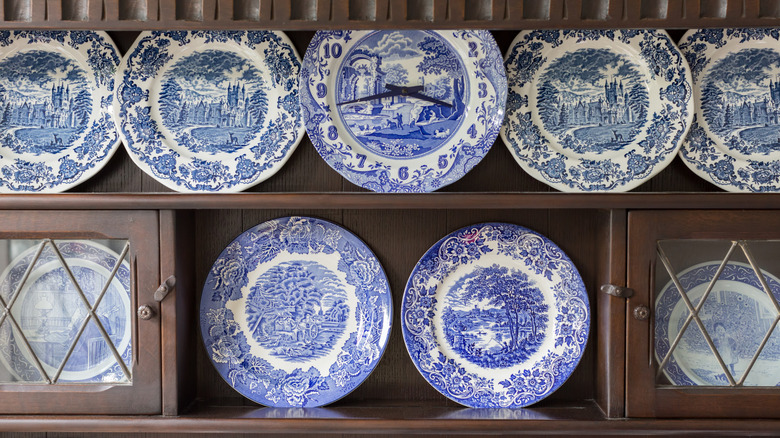 Antique plates displayed on wood cabinet