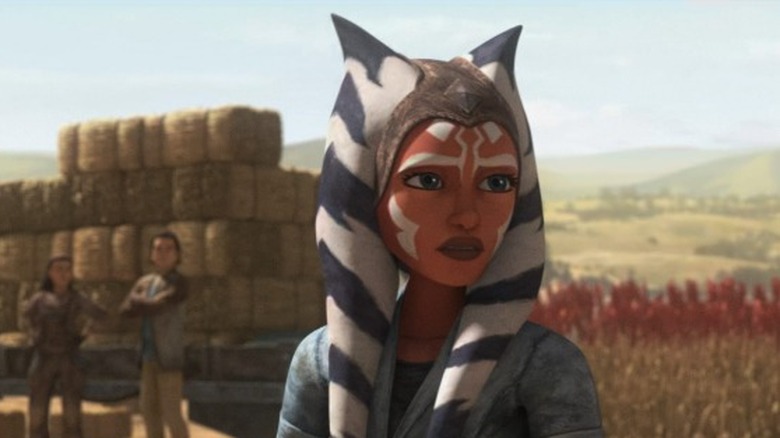 Ahsoka standing in a field.