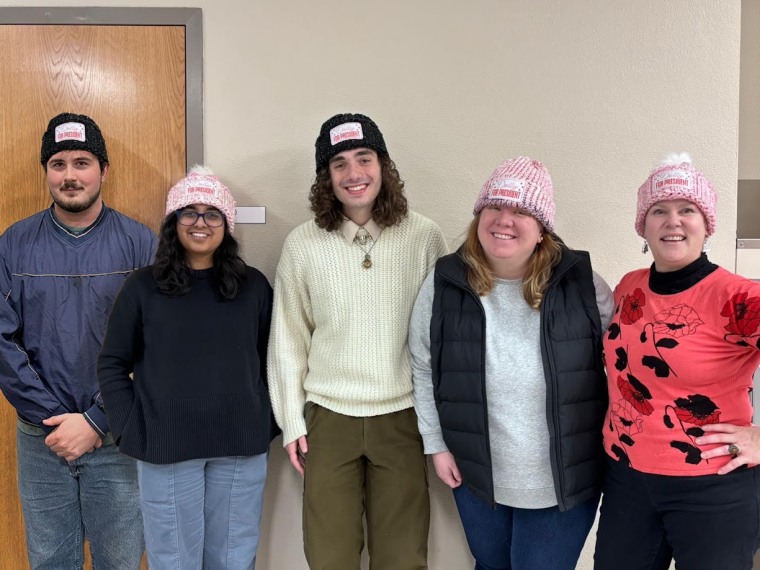 Undergraduate Teaching Assistants Danin Richardson, Kruti Subbannavar, Marc Louly, graduate associate instructor Rachel Seymour and professor Sarah Phillips wearing "Dolly for President" hats Phillips hand-knitted.