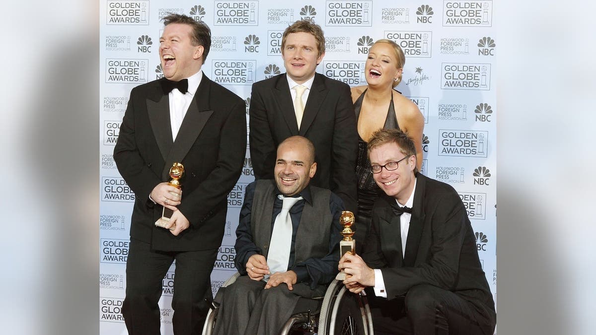 Ricky Gervais, Stephen Merchant, Ash Atalla, Lucy Davis and Martin Freeman pose backstage at the Golden Globe Awards.