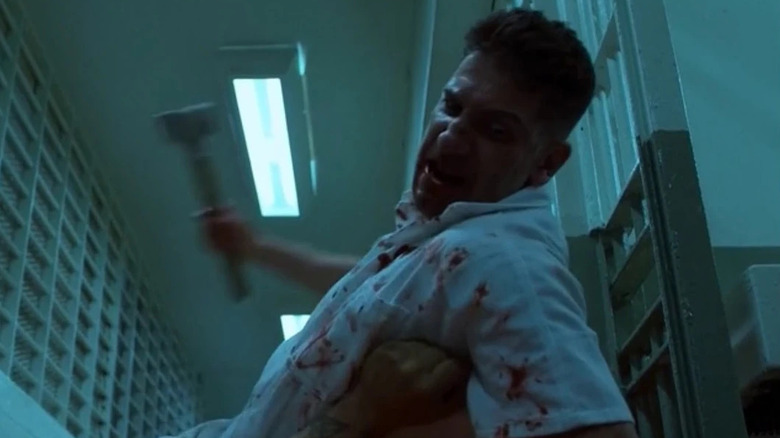 Jon Bernthal as Frank Castle wielding a hammer over a bloodied victim in The Punisher