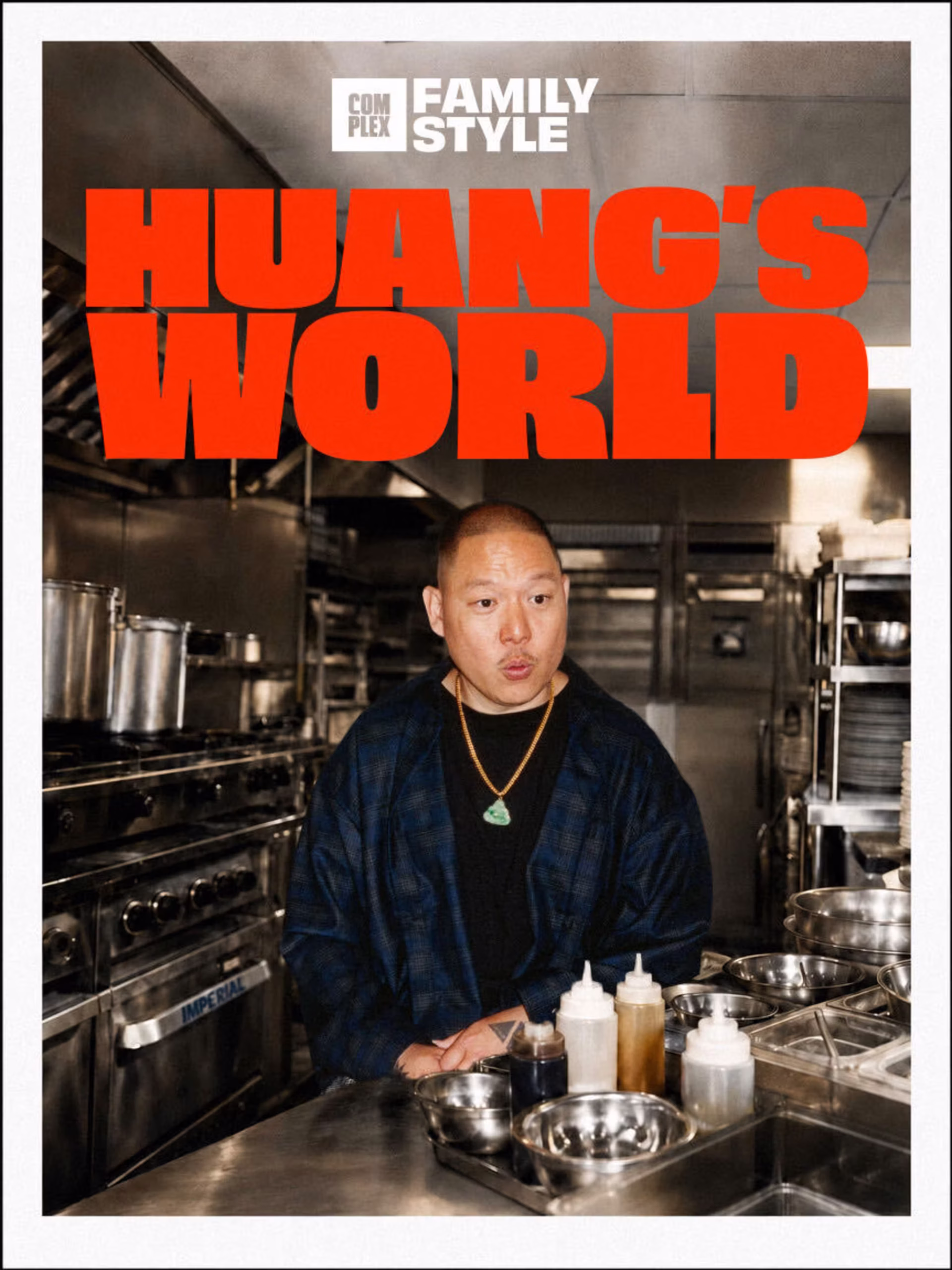 Eddie Huang stands in a professional kitchen with the text "Huang's World" above him. Various cooking utensils and ingredients are visible.