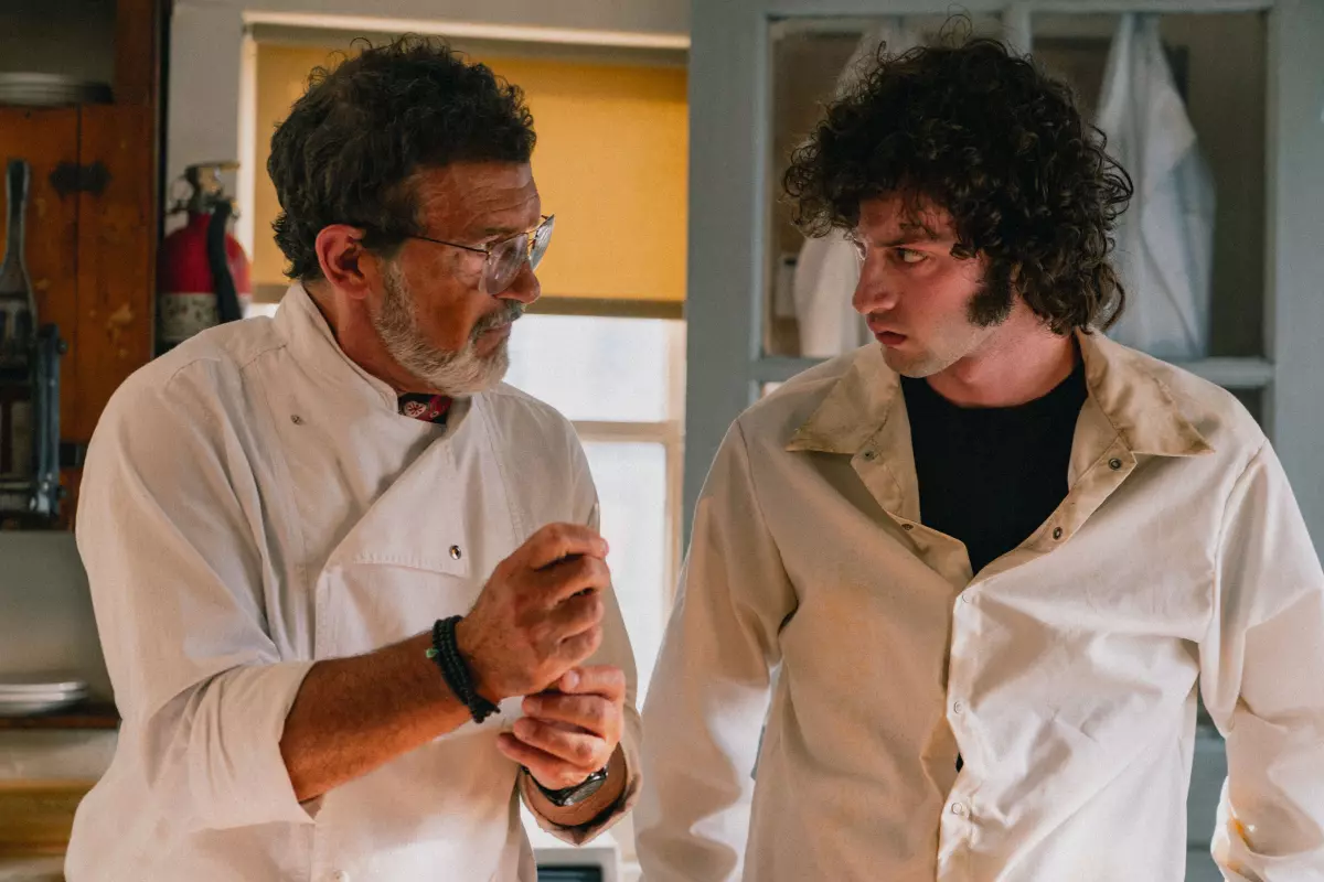 The new film Tony focuses on just a splinter of Anthony Bourdain's life — the mid-1970s summer when he was 19. Above, Antonio Banderas as Chef, and Dominic Sessa as a young Anthony Bourdain.