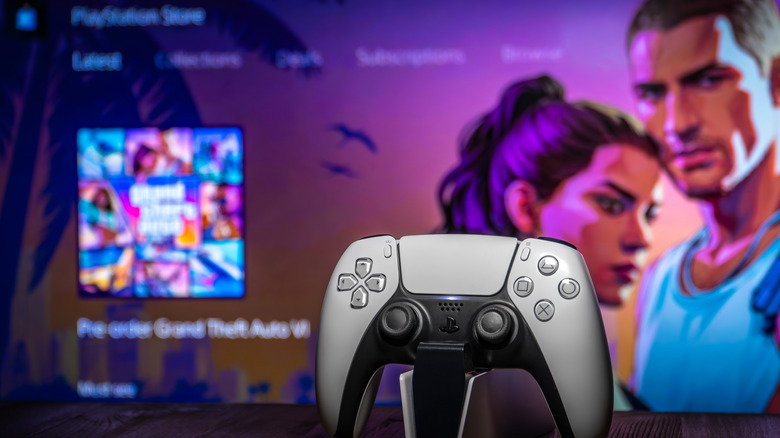 PlayStation 5 controller on a stand next to a digital pre-order of Grand Theft Auto 6 on PSN