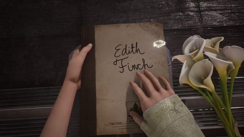 A girl holds her journal next to a flower in What Remains of Edith Finch