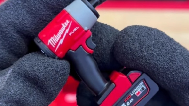 Person holding one of Milwaukee Tool's promotional mini tools.