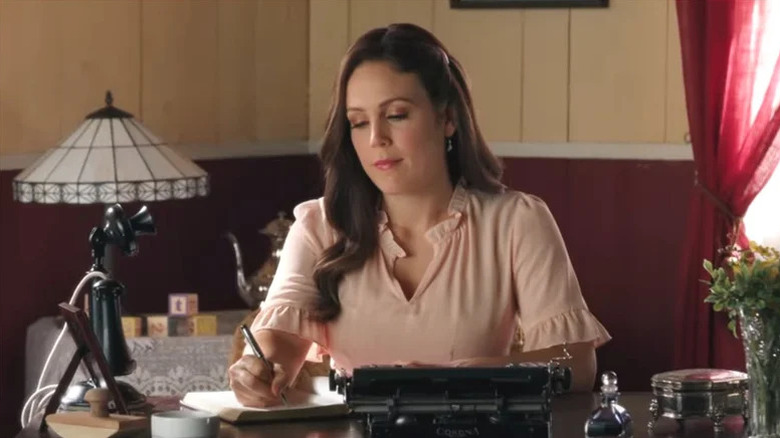 Erin Krakow's Elizabeth Thatcher writing with a pen on When Calls the Heart