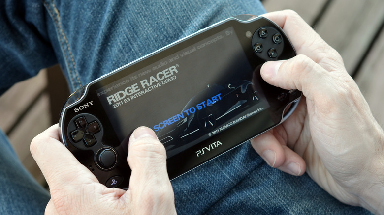 A person playing a PlayStation Vita
