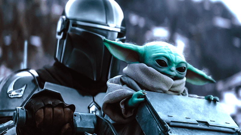 Din Djarin and Grogu on an AT-ST walker in 'The Mandalorian and Grogu.'
